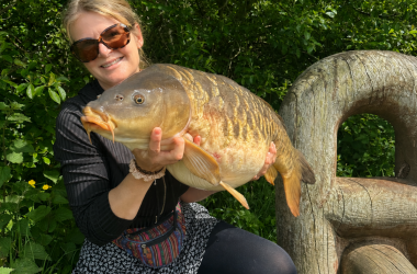 A superb mirror carp caught by Louise Banks using a dog treat weighing in at 24lb 3oz